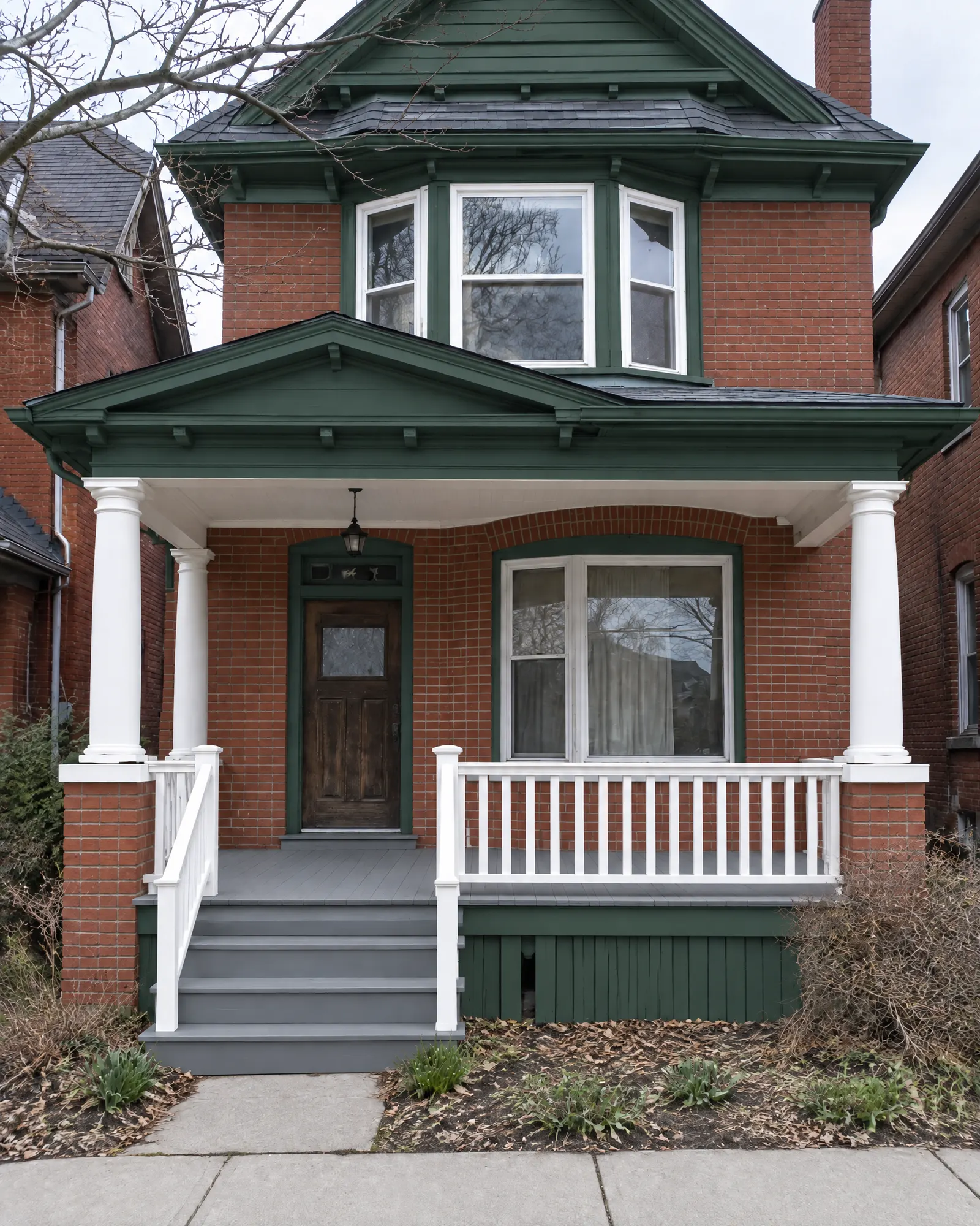 Edwardian brick house porch from the sidewalk, before and after restoration (after)